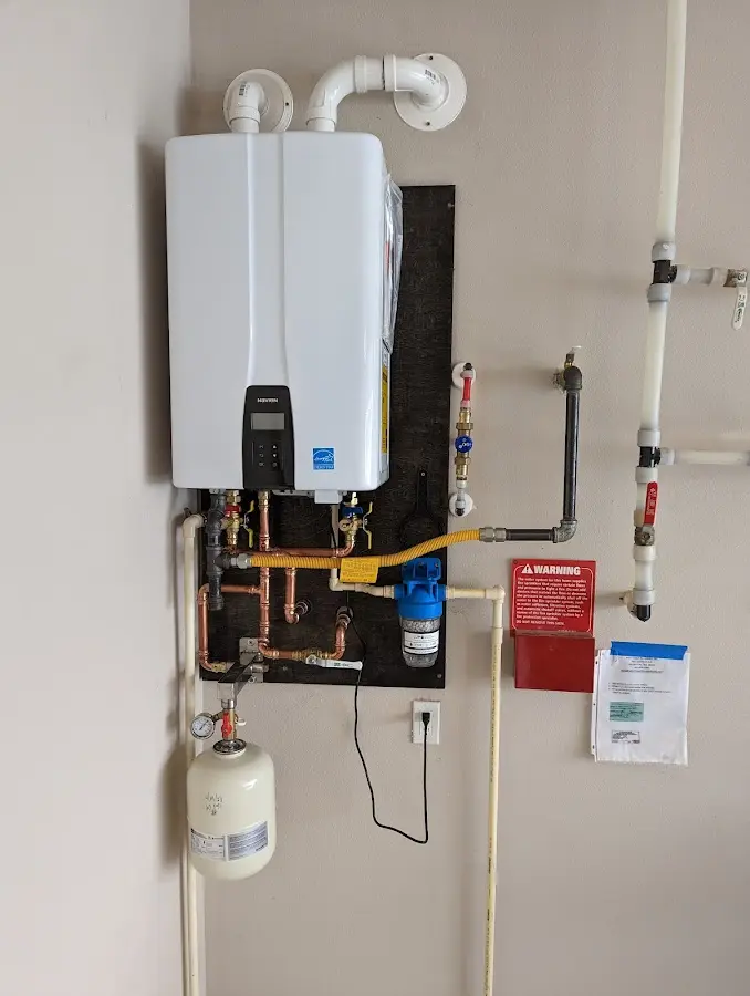 Professional plumber installing copper piping in a New Holland home